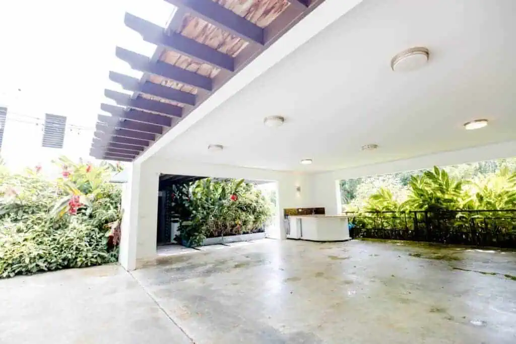 Spacious outdoor patio with modern design and lush greenery.
