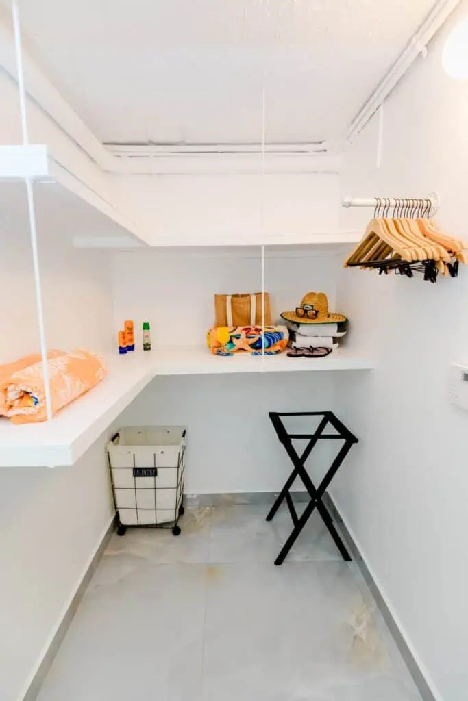 Clean and organized closet with hanging space and storage baskets.