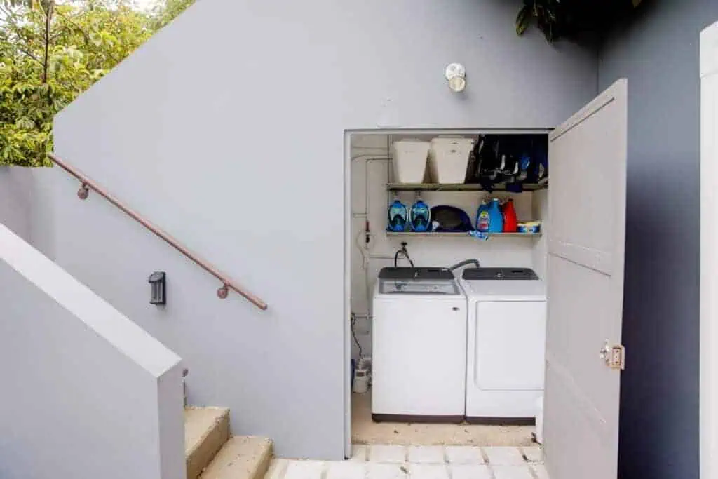 Laundry area with washer, dryer, and storage in outdoor space.