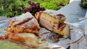 Sweet dessert with grapes, caramel, and chocolate on a glass plate.