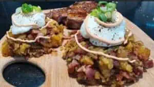 Loaded potato skins topped with sour cream, green onions, and bacon bits.