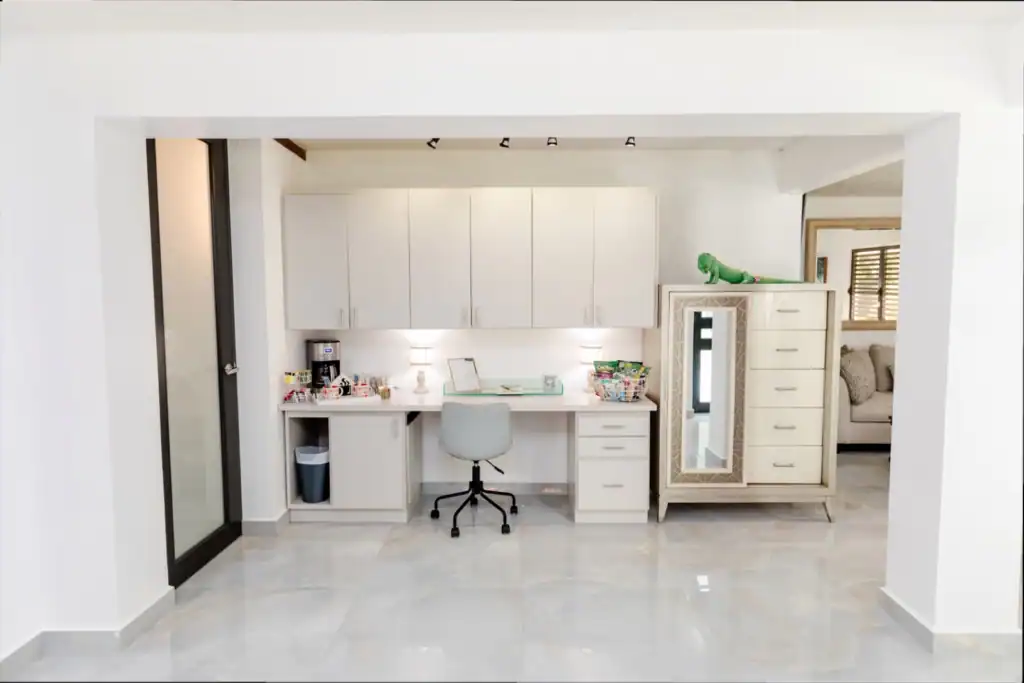 Contemporary home office with white cabinets and a desk.